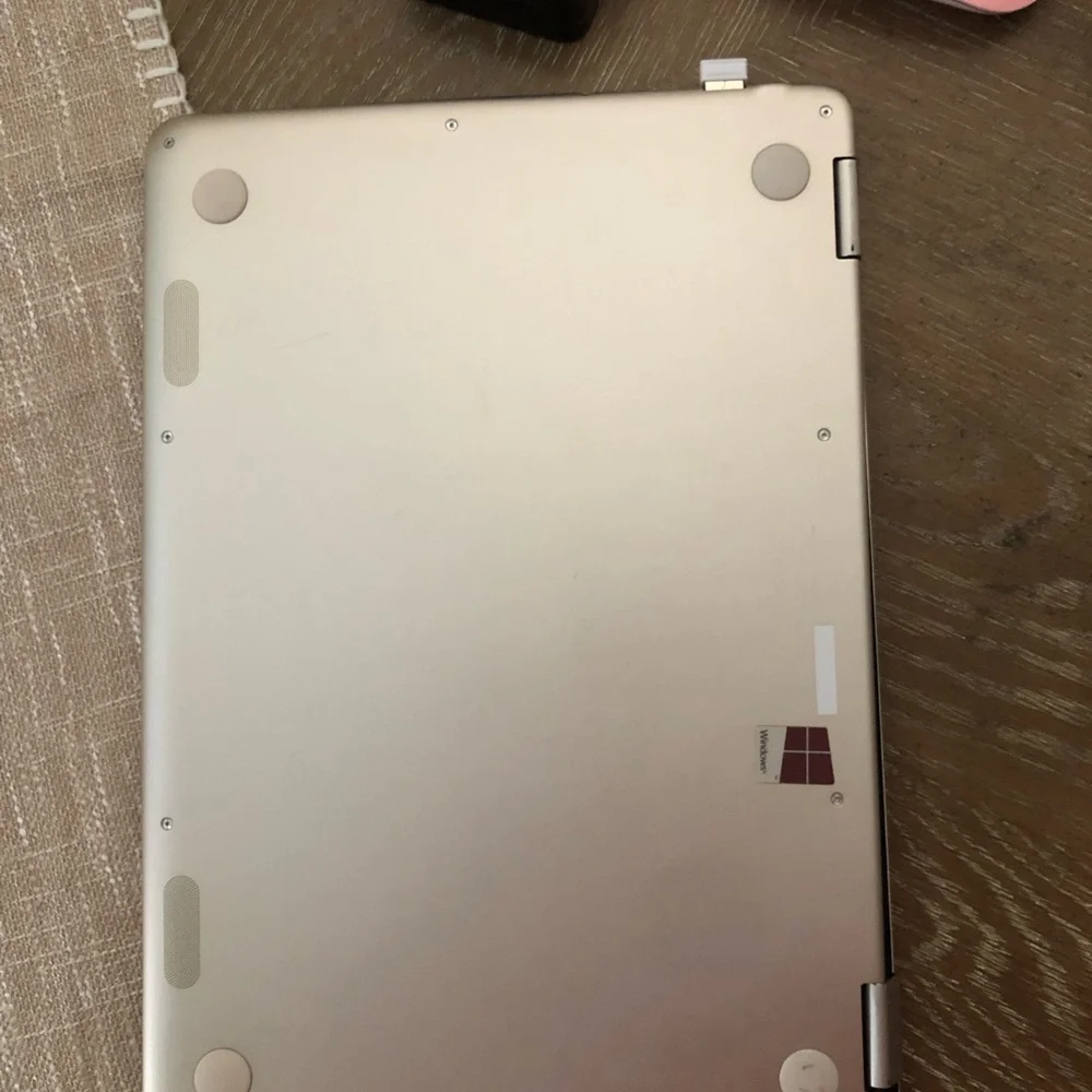 ASUS Metallic Silver Convertible Laptop with a wireless mouse and a charger.